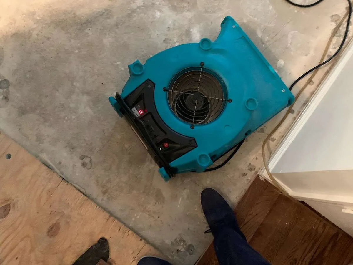 Air mover drying subfloor during Commercial Water Damage Restoration in Estes Park